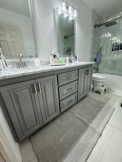 A bathroom with a sink , toilet , and mirror.