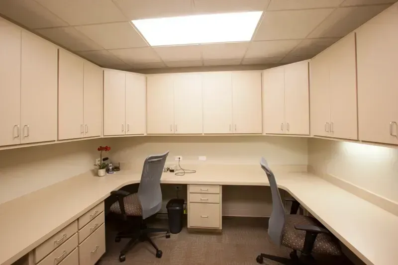 A small office with two desks and two chairs