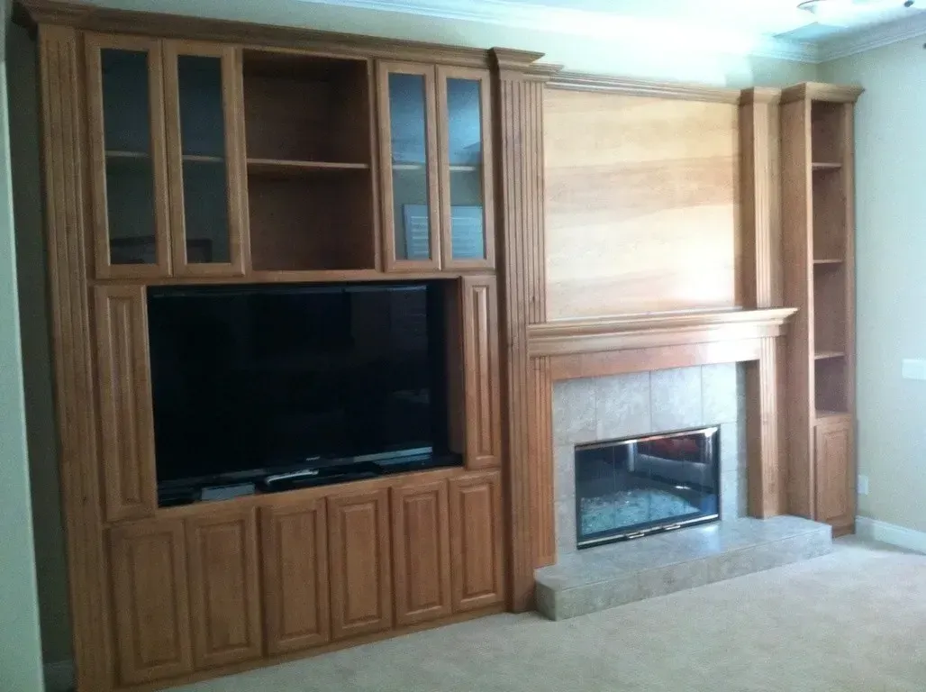 A living room with a fireplace and a flat screen tv