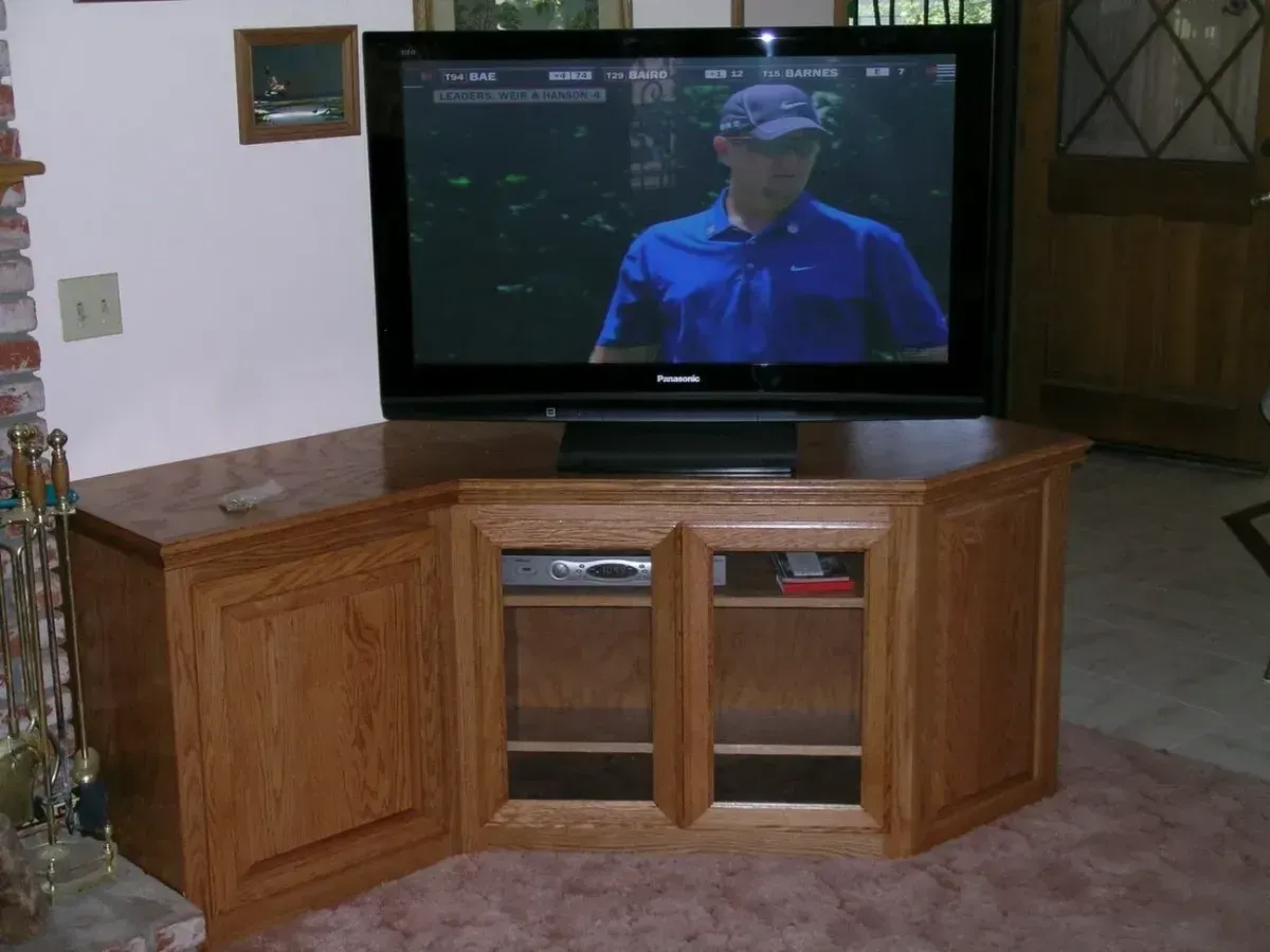 A flat screen tv is sitting on a wooden entertainment center