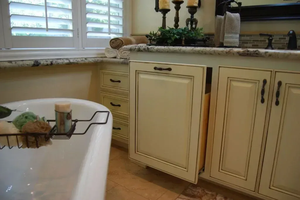 A bathroom with a tub , sink , and cabinets