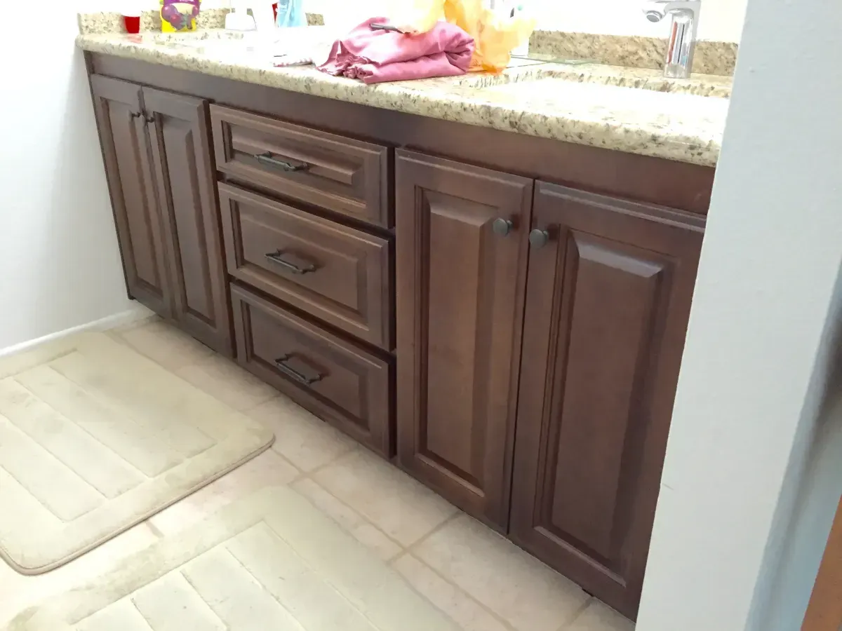 A bathroom with wooden cabinets and a sink