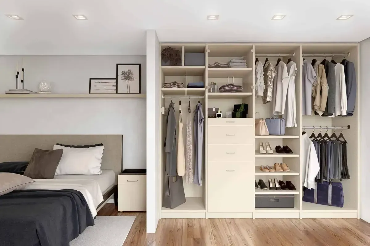 A bedroom with a bed and a walk in closet.
