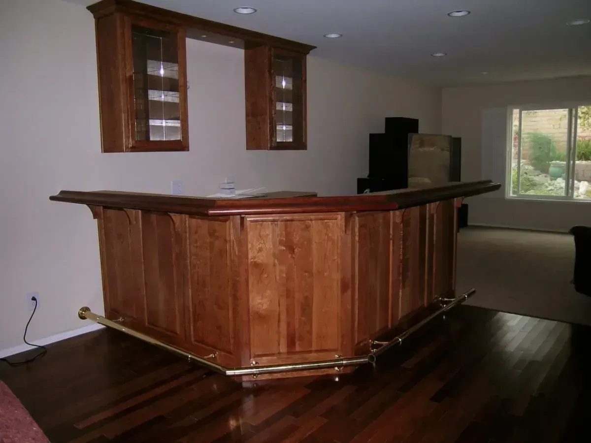 A wooden bar in a living room with hardwood floors