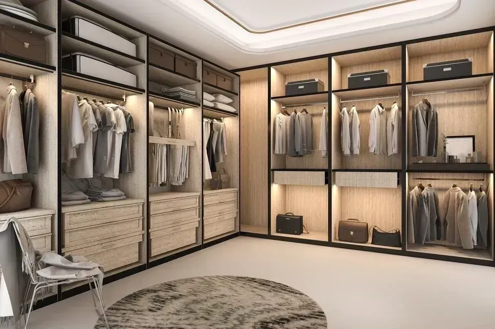 A walk in closet filled with lots of clothes and a chair.