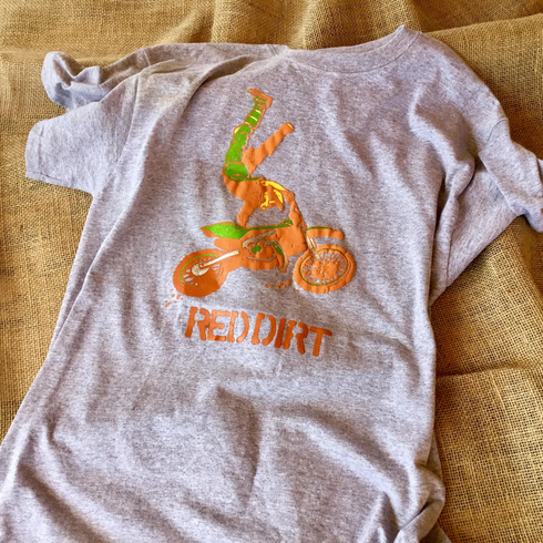 a grey t-shirt with an orange dirt bike on it