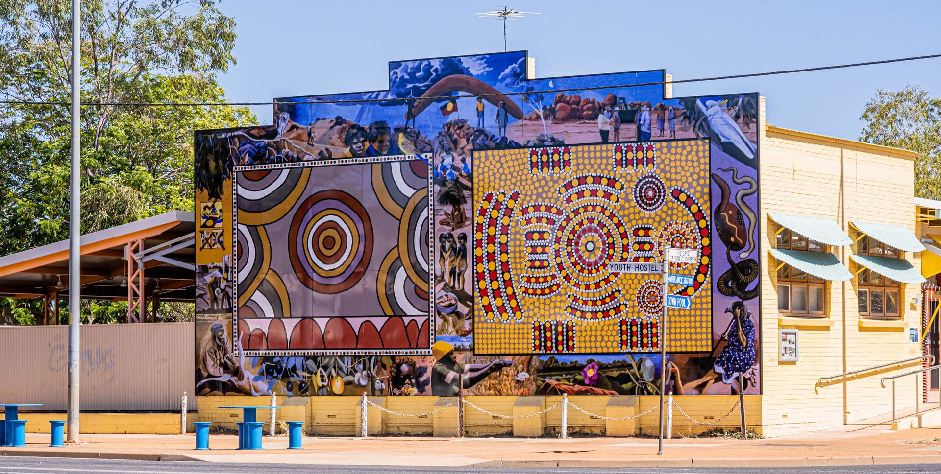 There is a large mural on the side of a building.