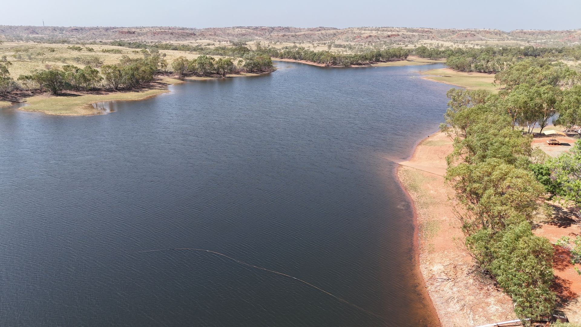 An aerial view of a large body of water surrounded by trees.