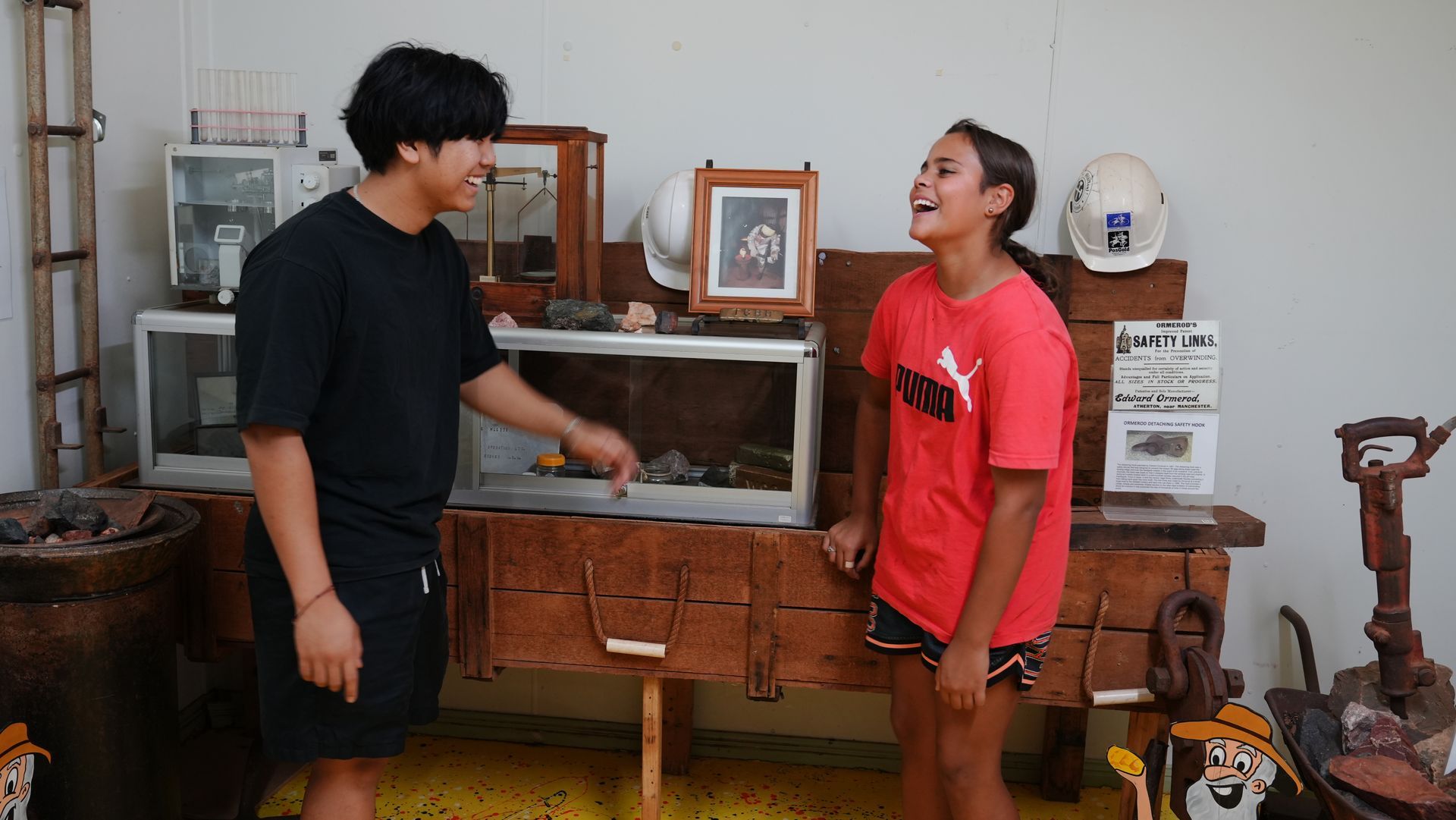 A man and a woman are standing next to each other in a room.