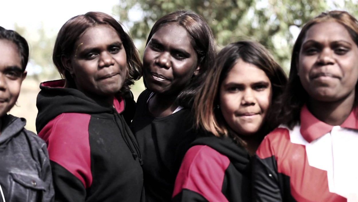 A group of women are posing for a picture together