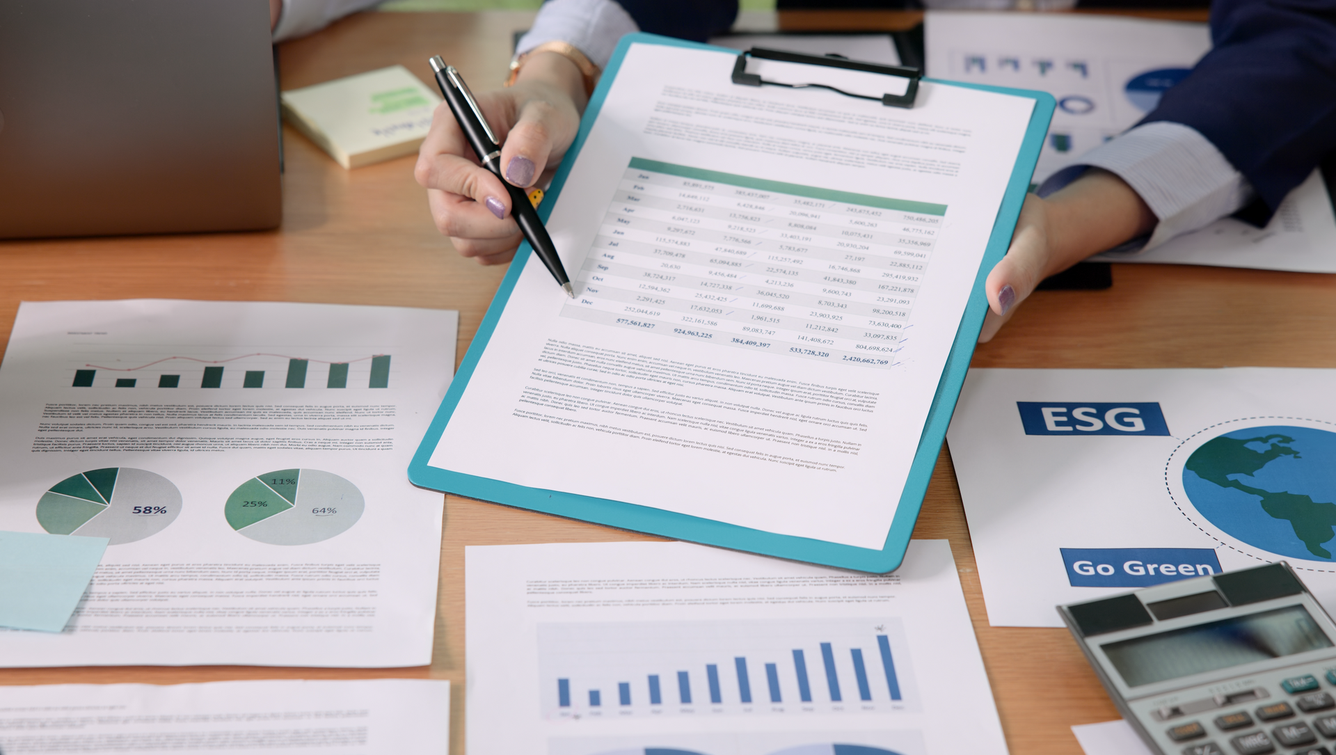 A person is writing on a clipboard with a pen.