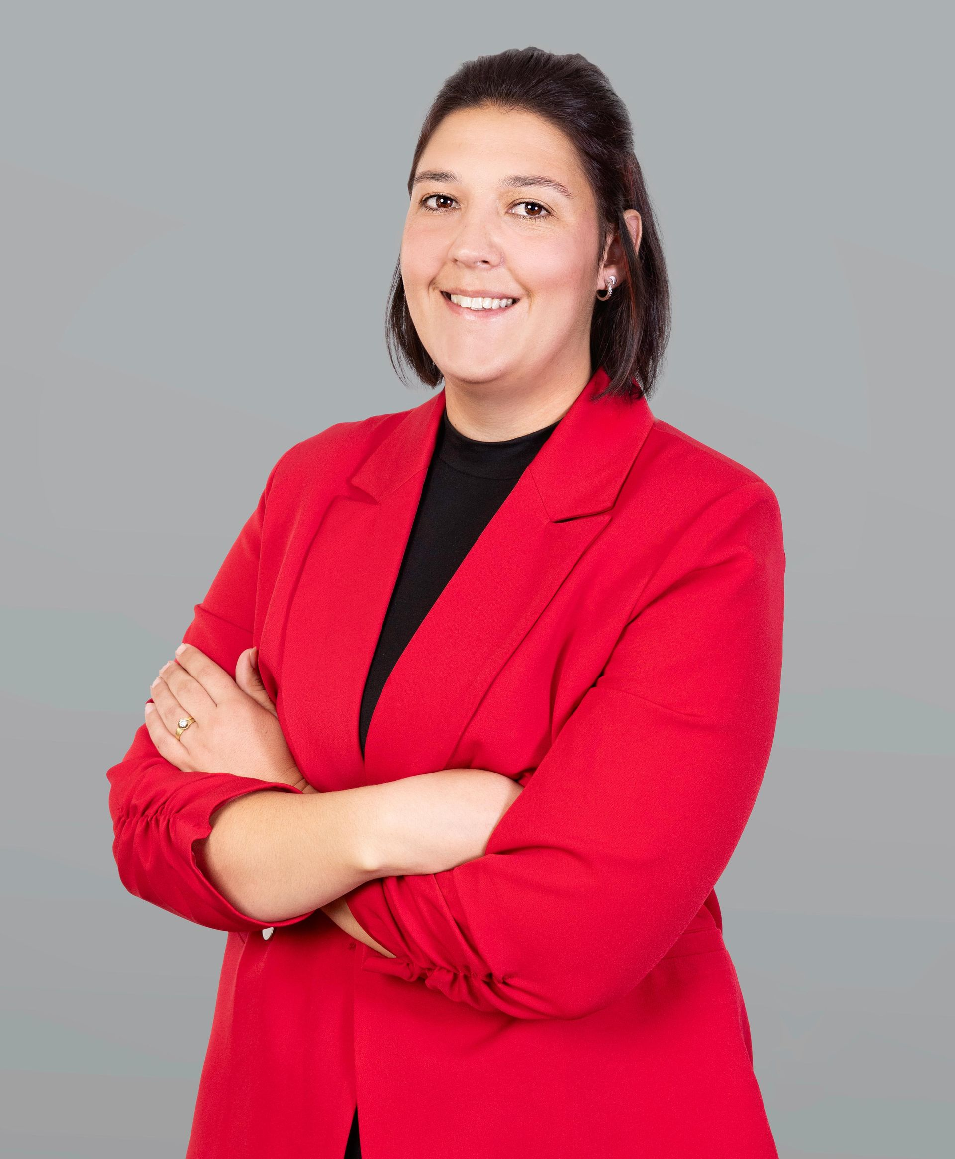 Woman in red blazer, smiling. Text: 