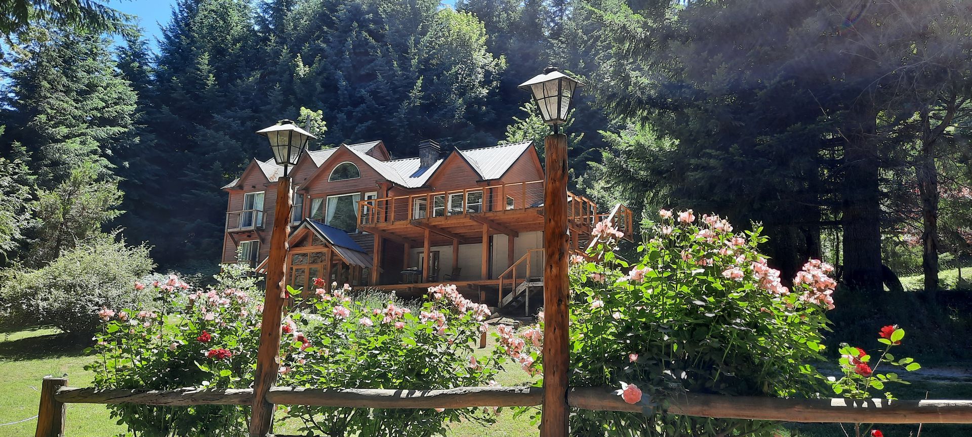 A large house with a wooden sign in front of it