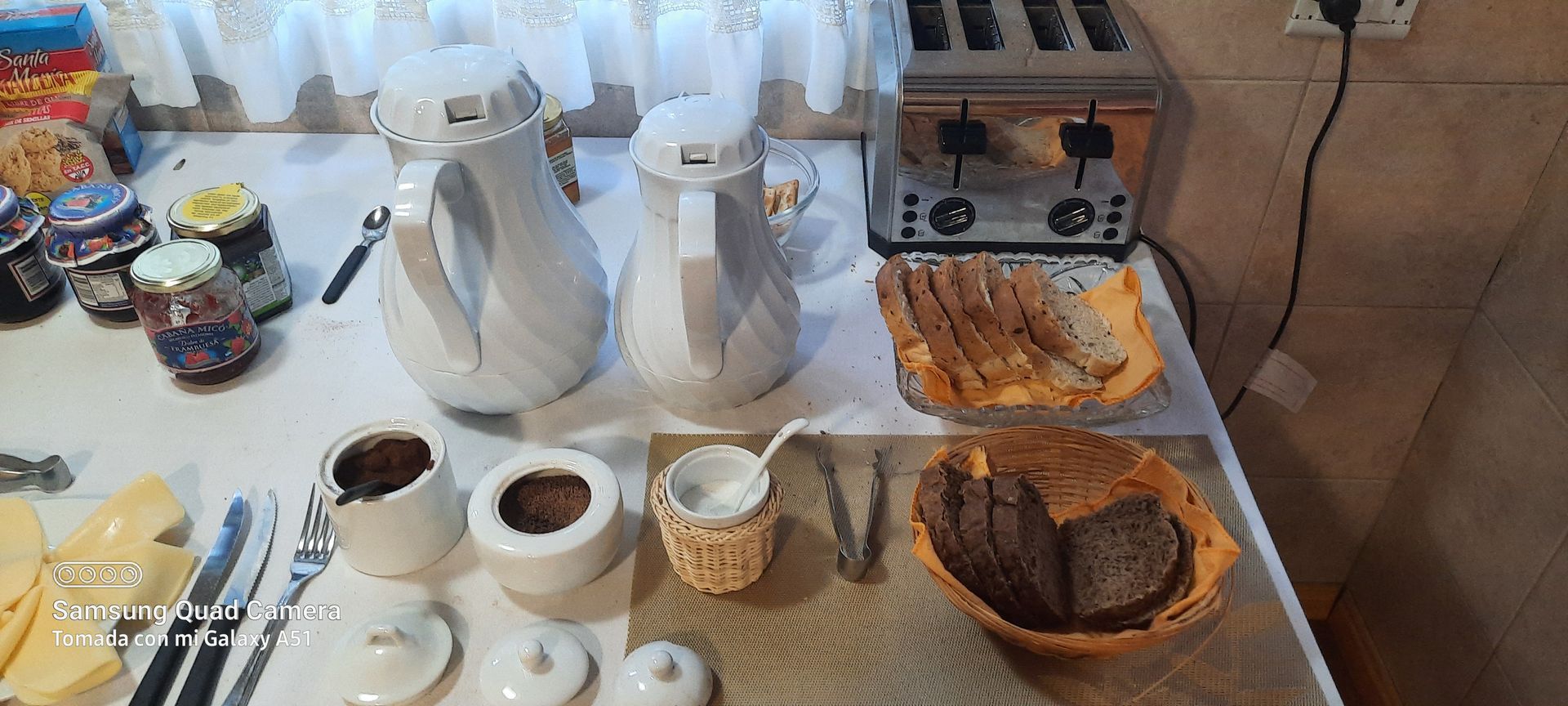A table with a bunch of food on it and a toaster oven.