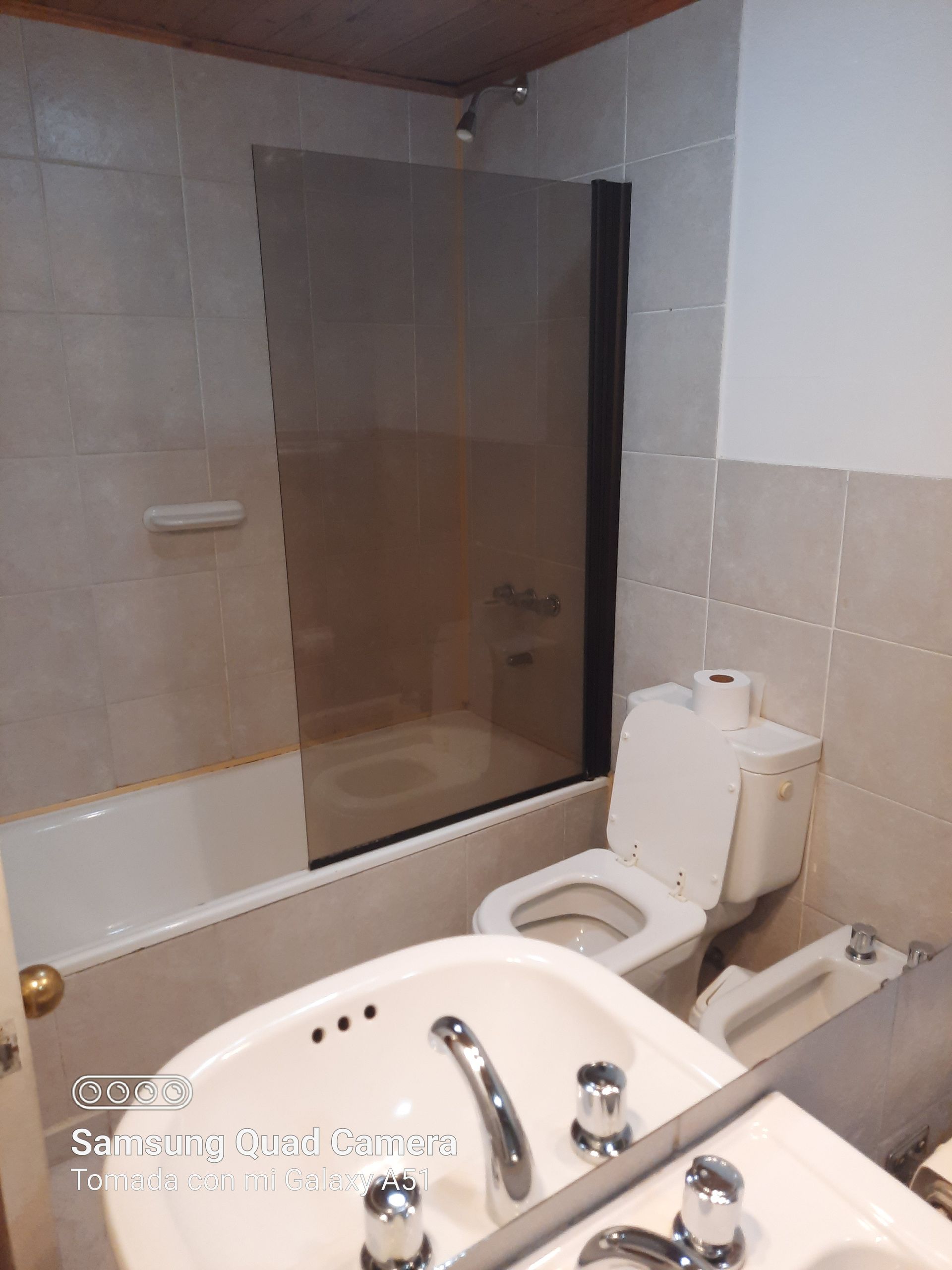 A bathroom with a toilet a sink and a bathtub