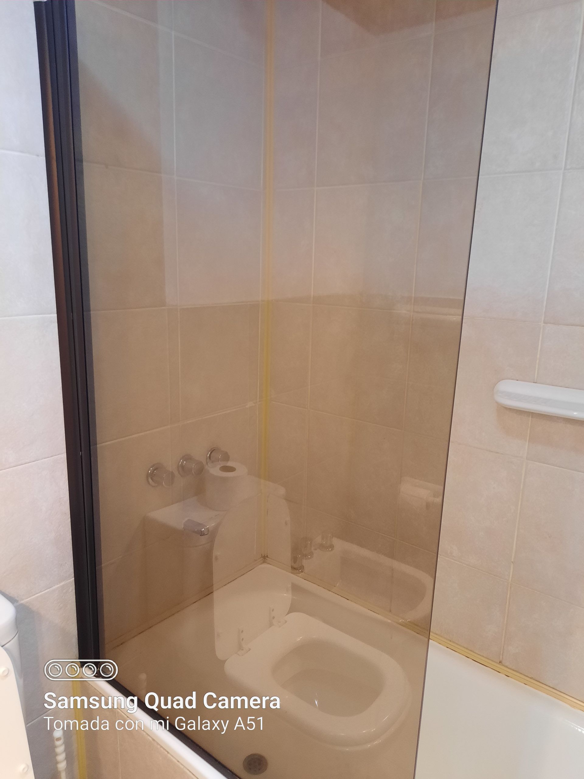 A bathroom with a toilet , sink and bathtub.