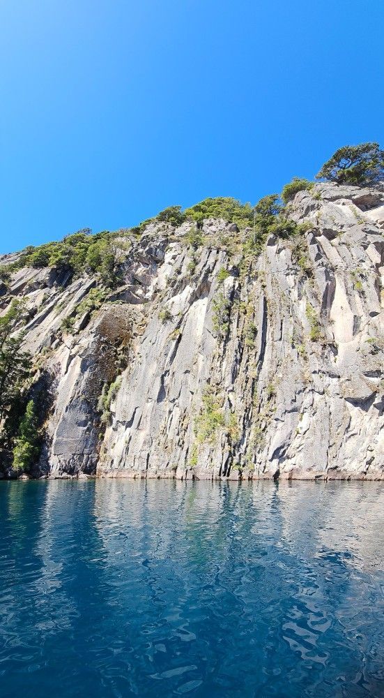 A large rocky cliff overlooking a body of water.