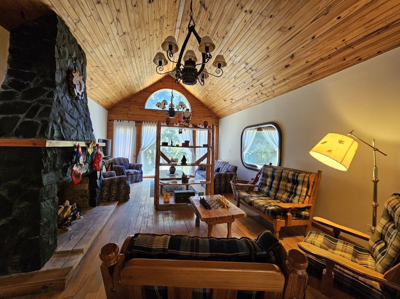 A living room with wooden furniture and a fireplace