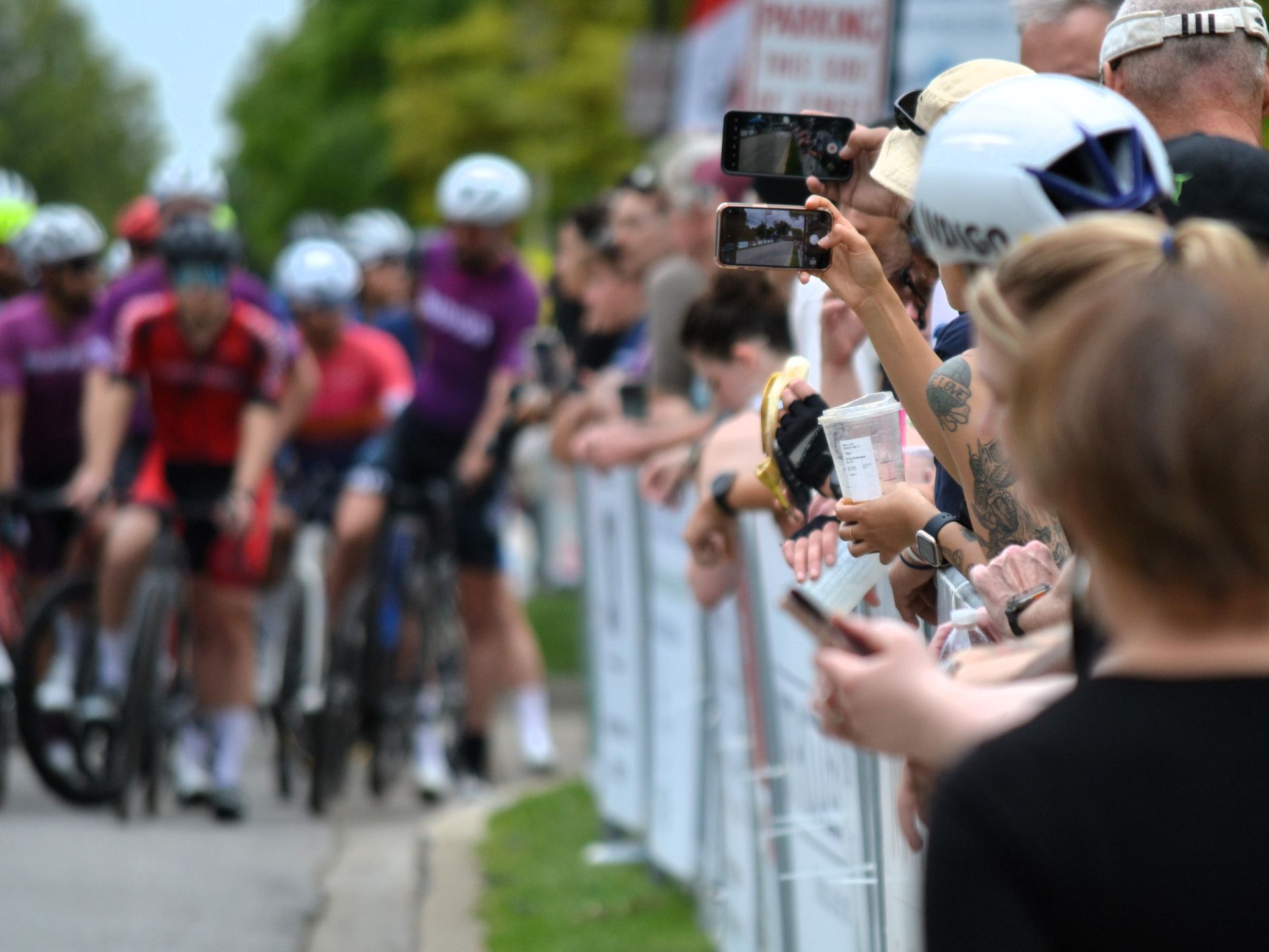 A crowd of people are watching a bicycle race