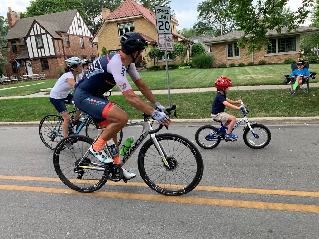 A group of people are riding bicycles down a street.
