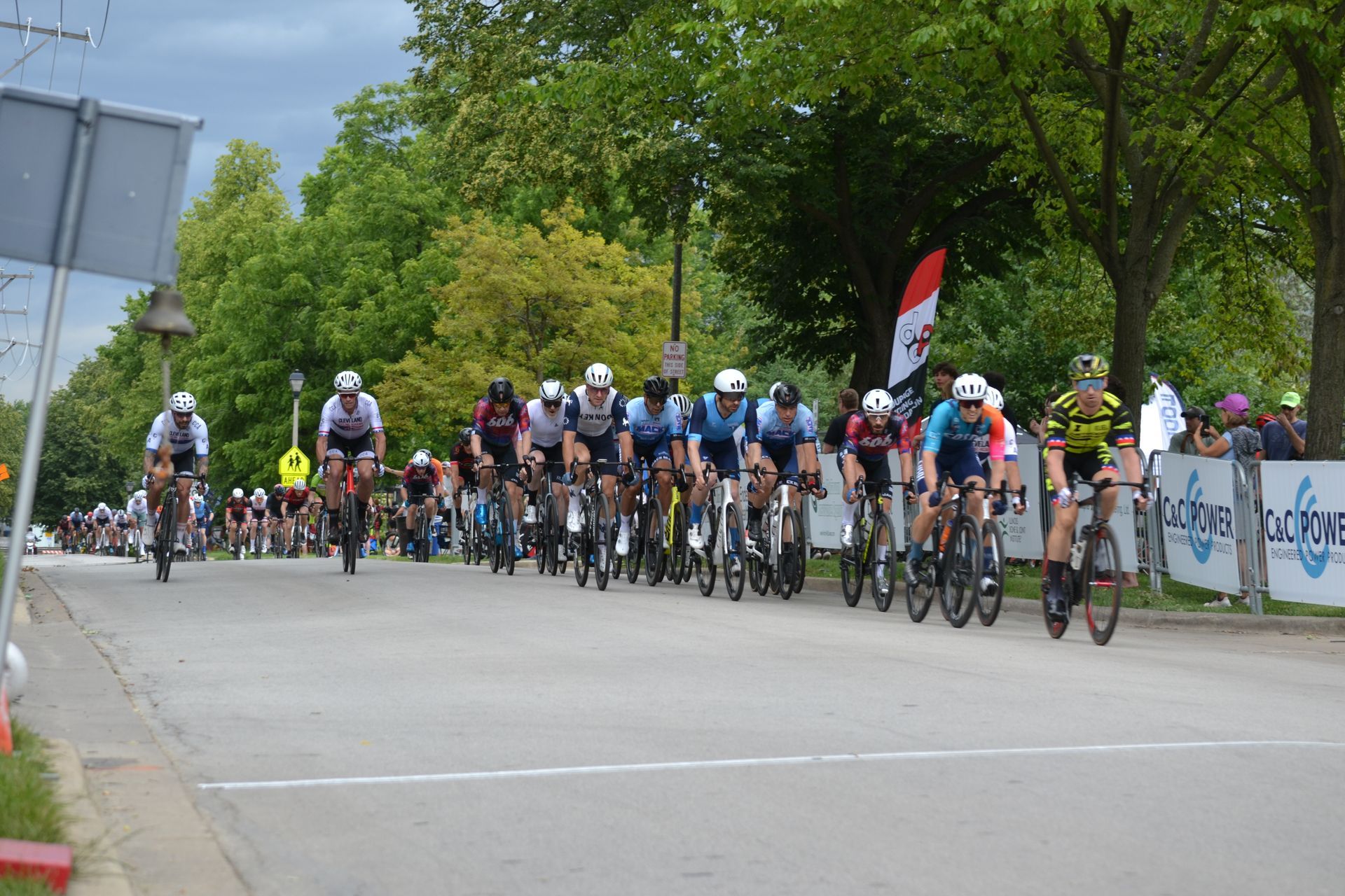 A group of people are riding bicycles down a street.