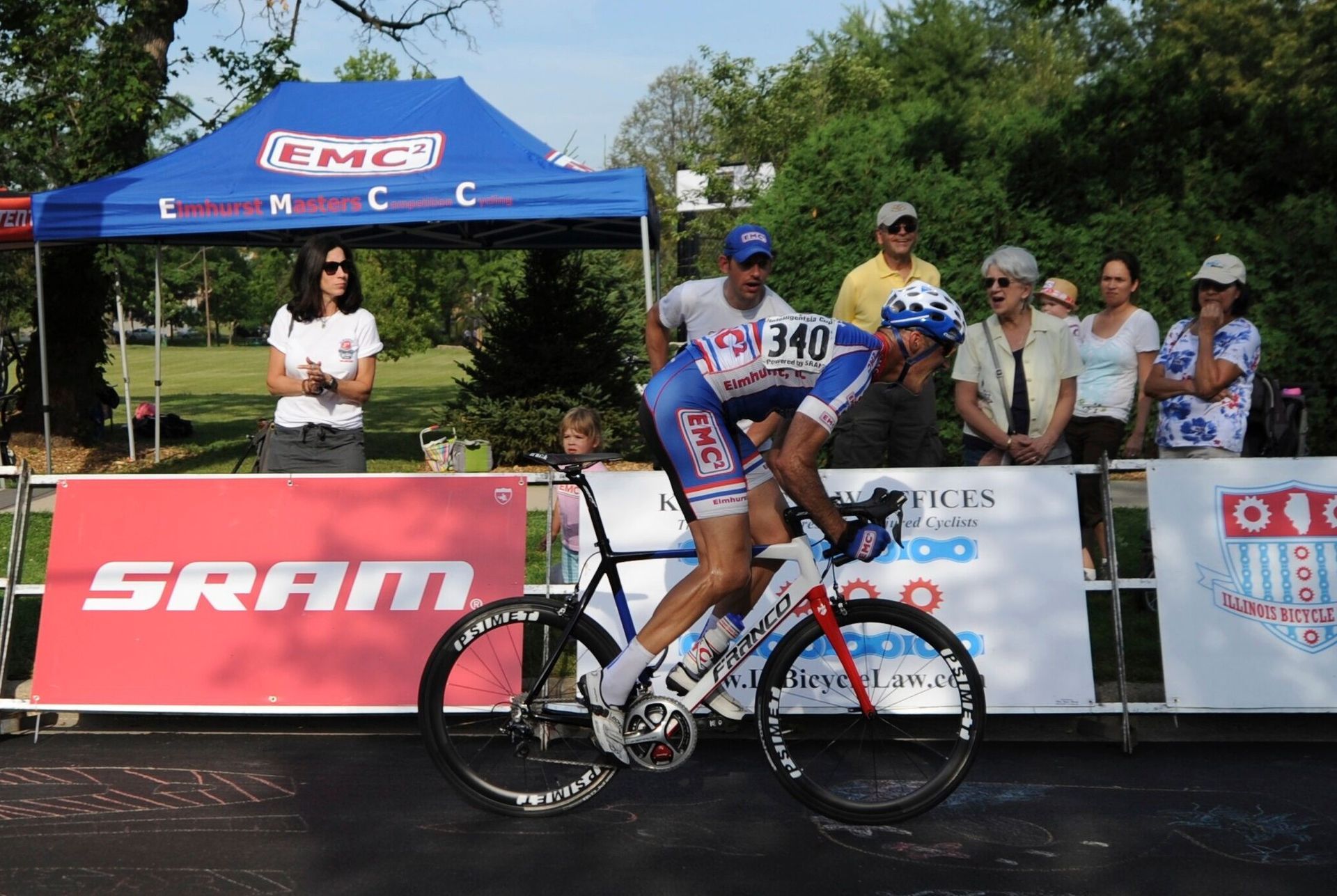 A man riding a bike in front of a sram sign