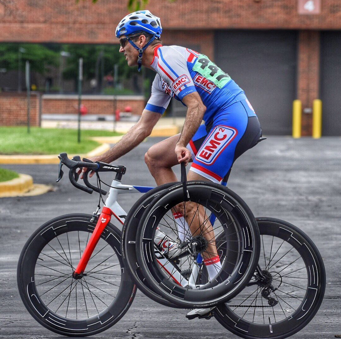 A man riding a bike with the number 997 on his back