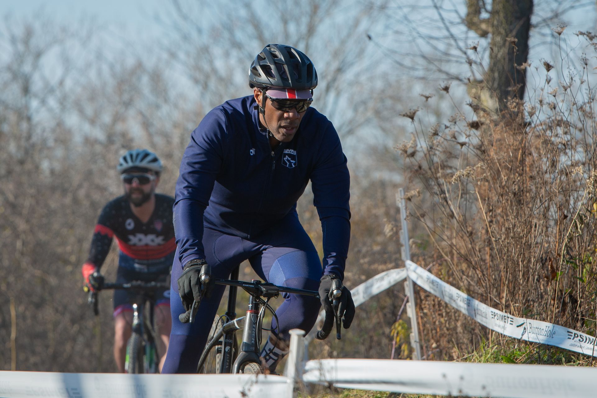 A man is riding a bike down a hill.