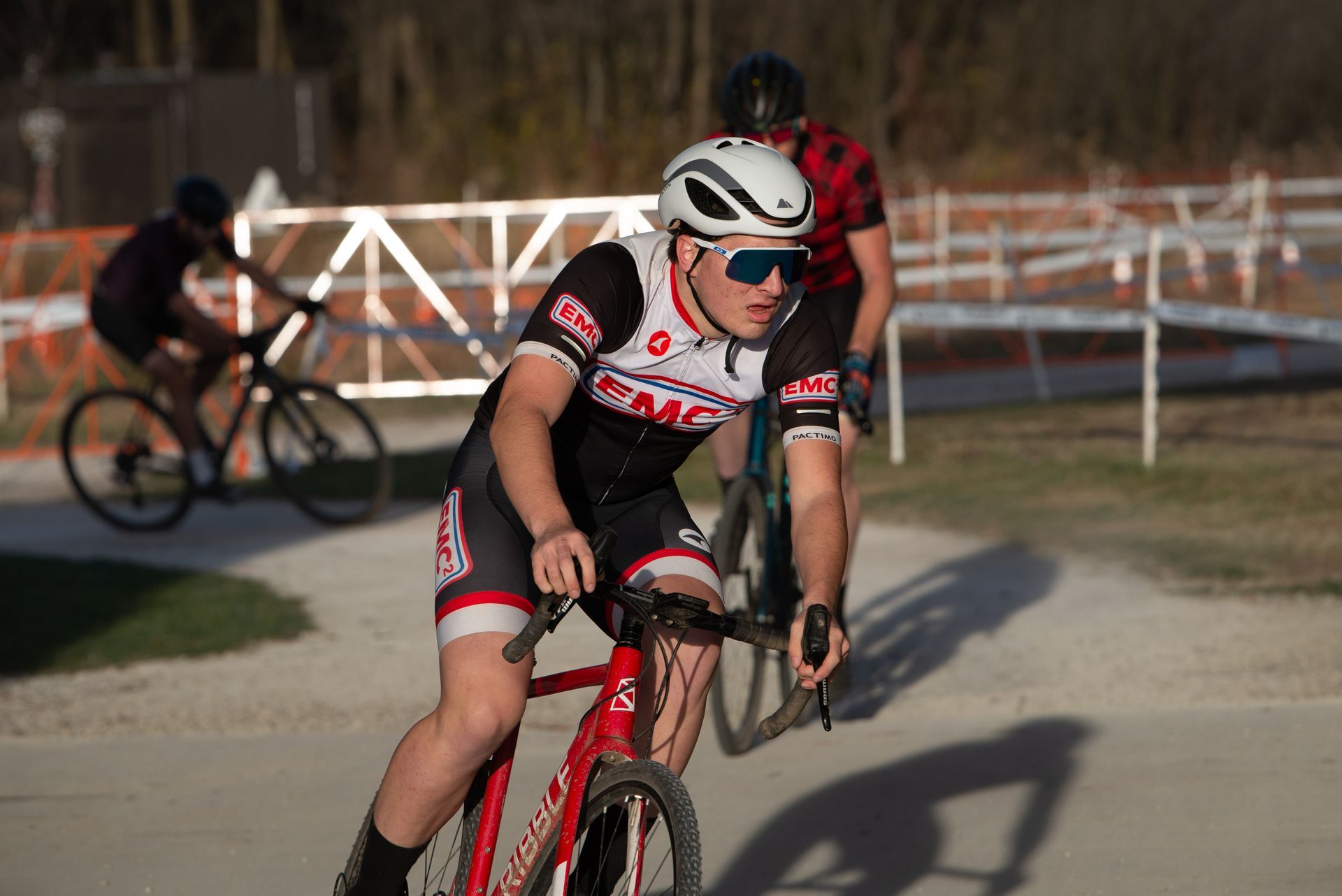 A man is riding a bike on a dirt road.
