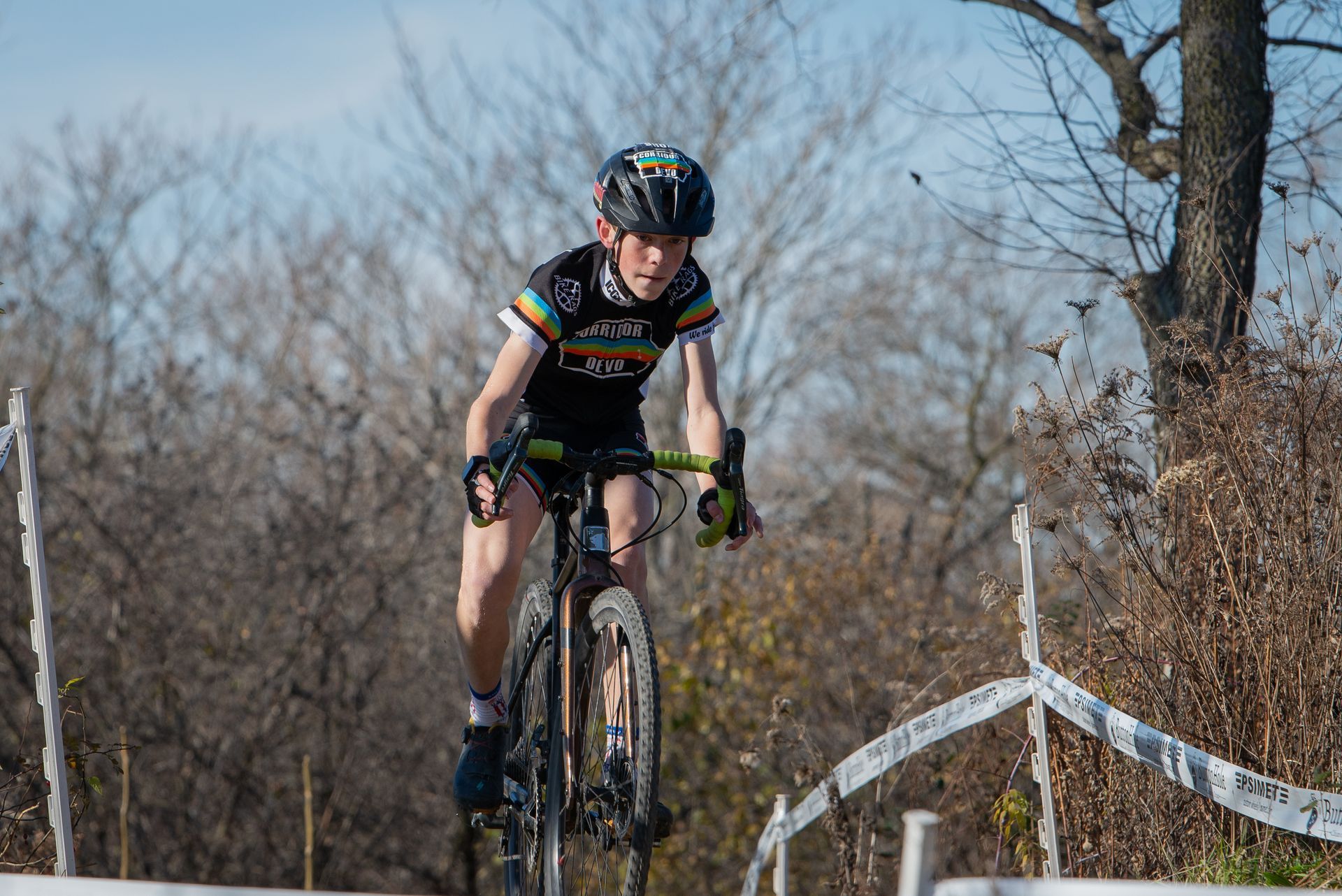 A young boy is riding a bike on a dirt road.