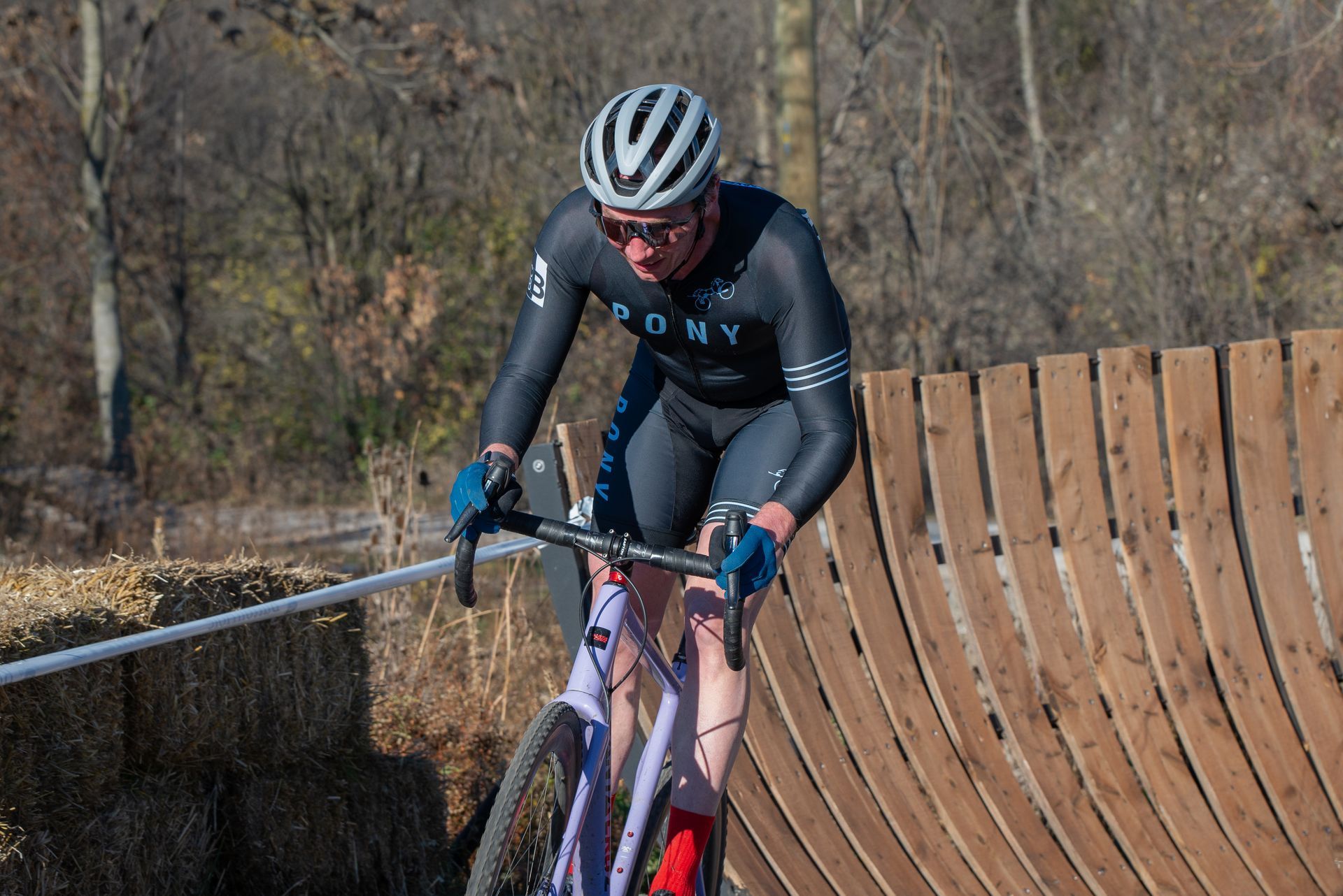 A man is riding a bike on a wooden ramp.