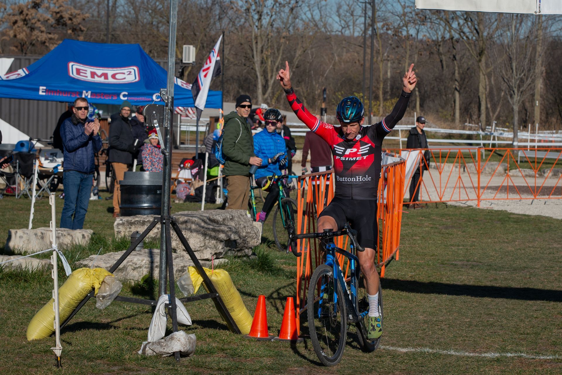 A man is riding a bike with his arms in the air.