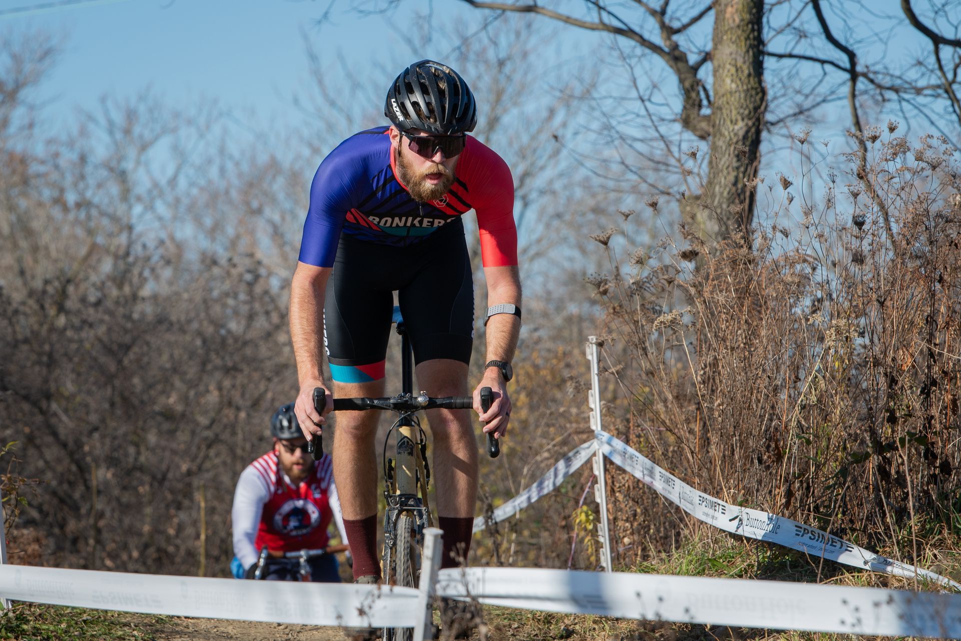 A man is riding a bike on a dirt road.