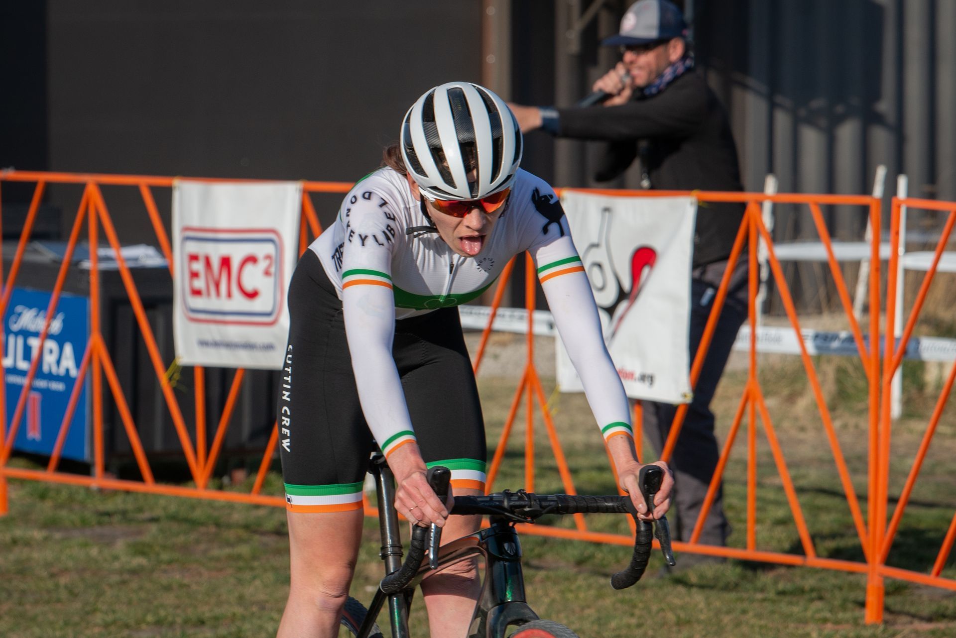 A woman is riding a bike on a grassy field.