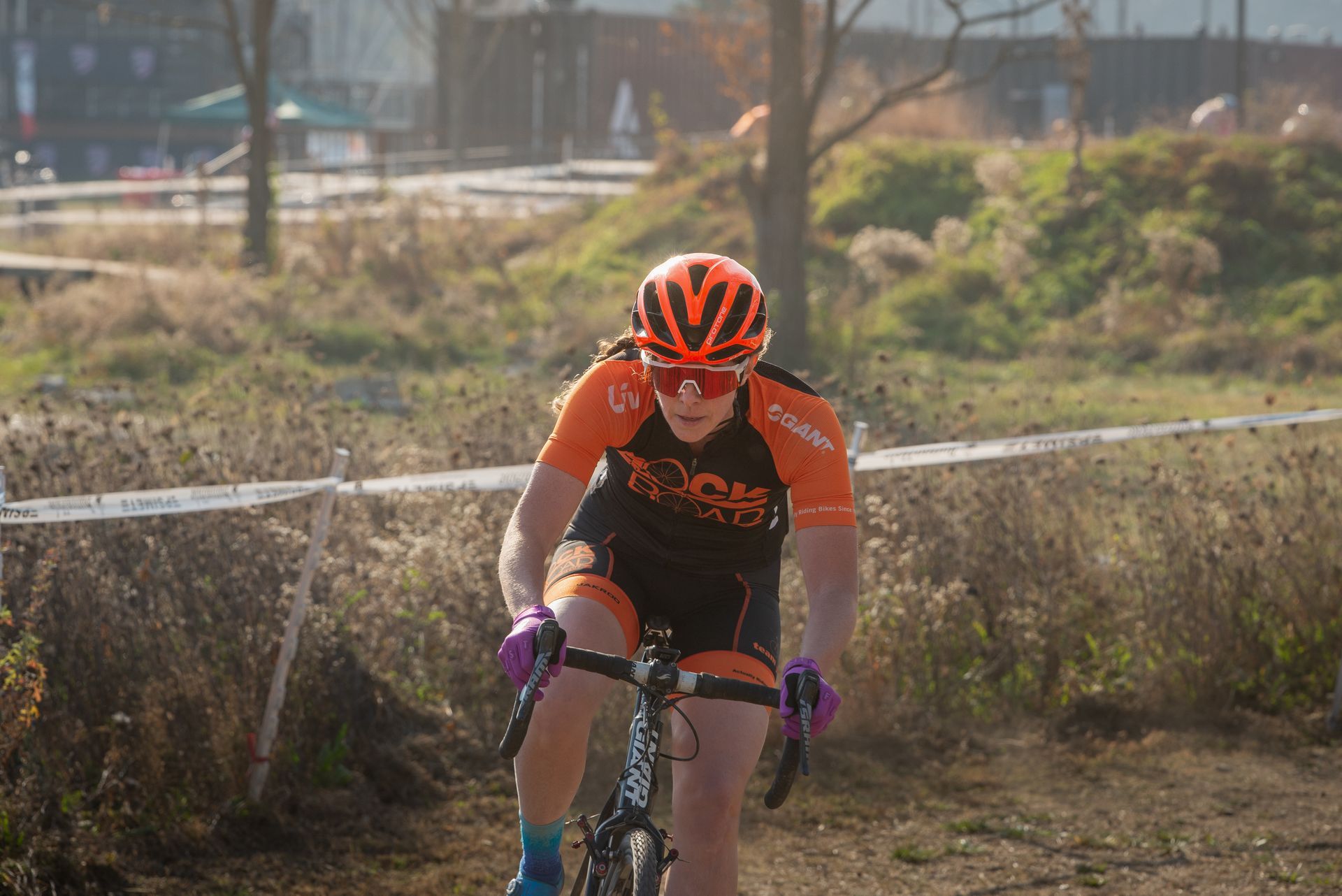 A person is riding a bike on a dirt road.