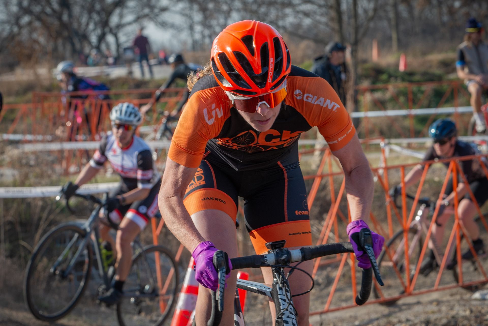A woman is riding a bike in a race.