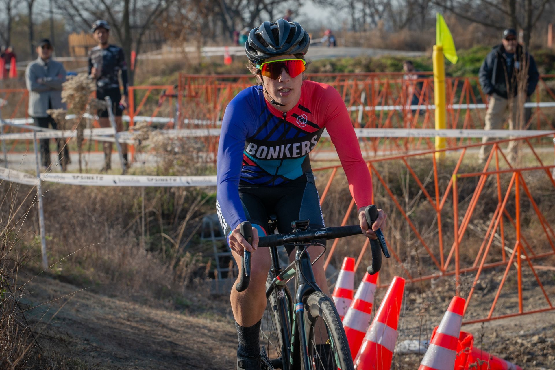 A woman is riding a bike on a dirt road.