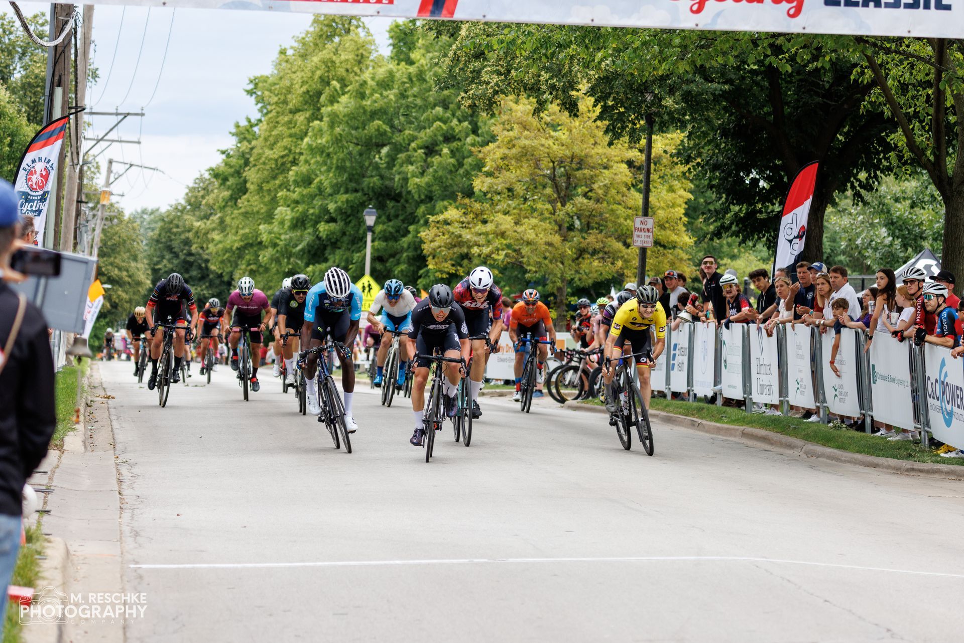 A group of people are riding bicycles down a street.