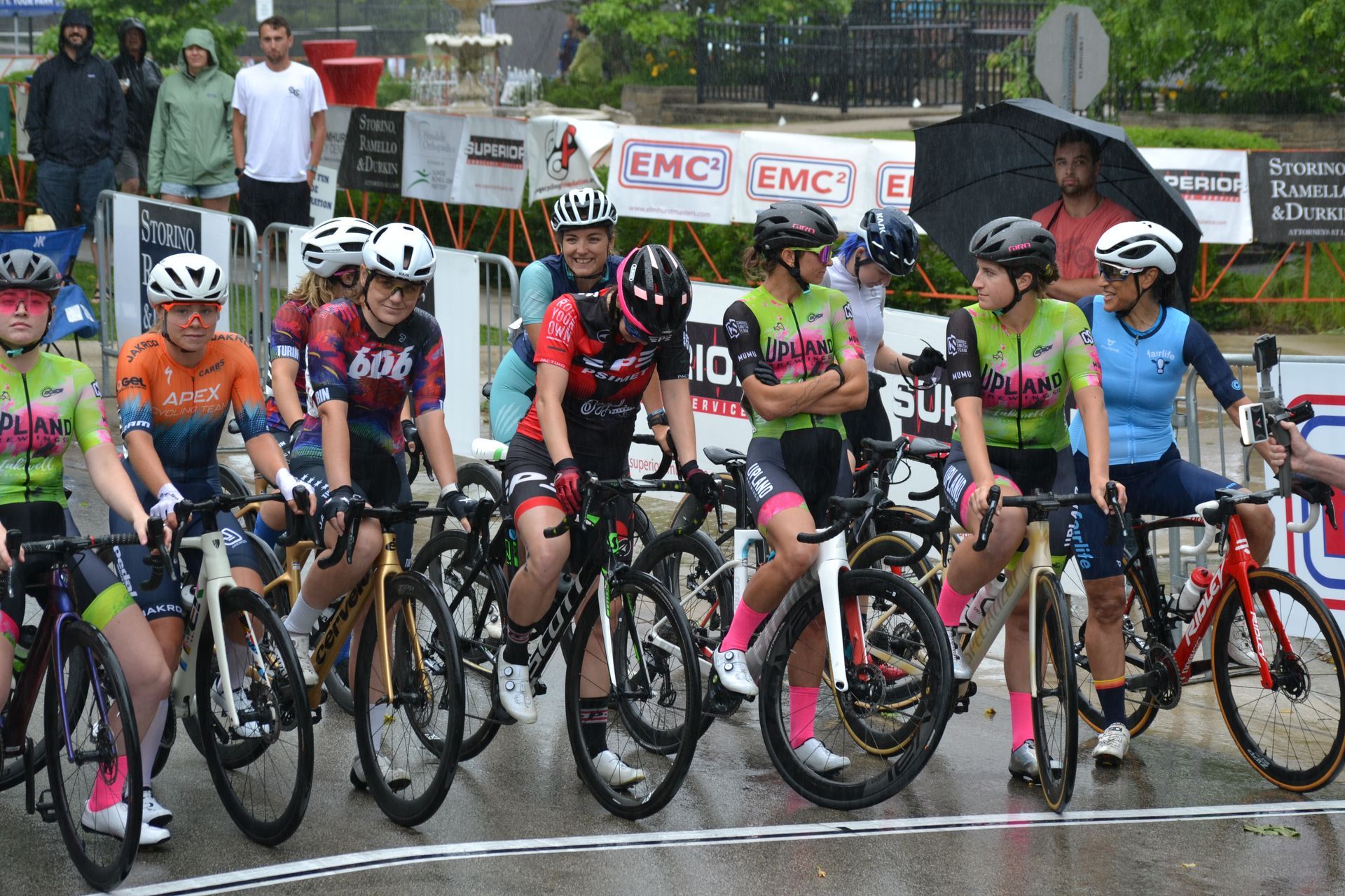 A group of people are riding bicycles in the rain.