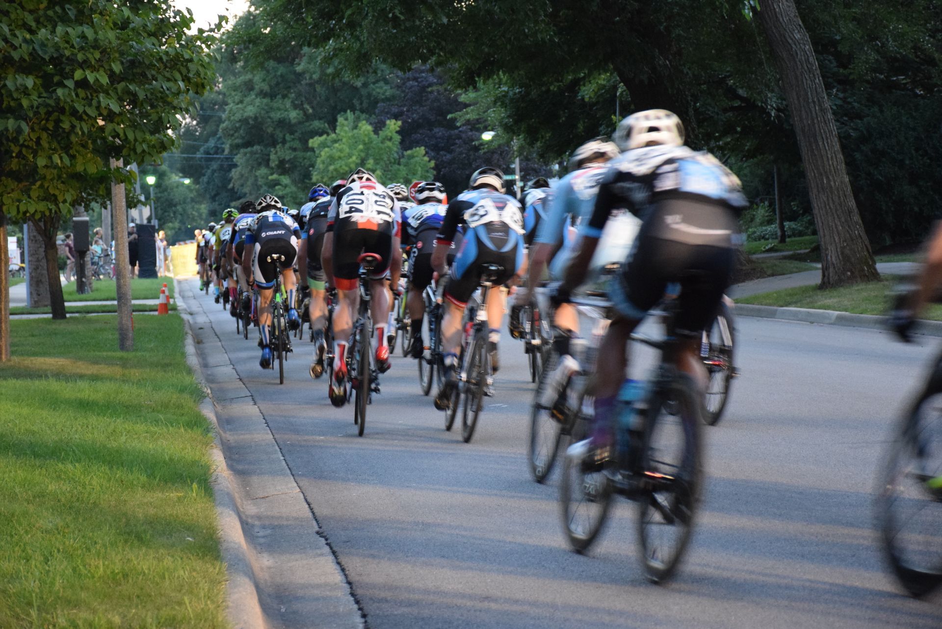A group of people are riding bicycles down a street.