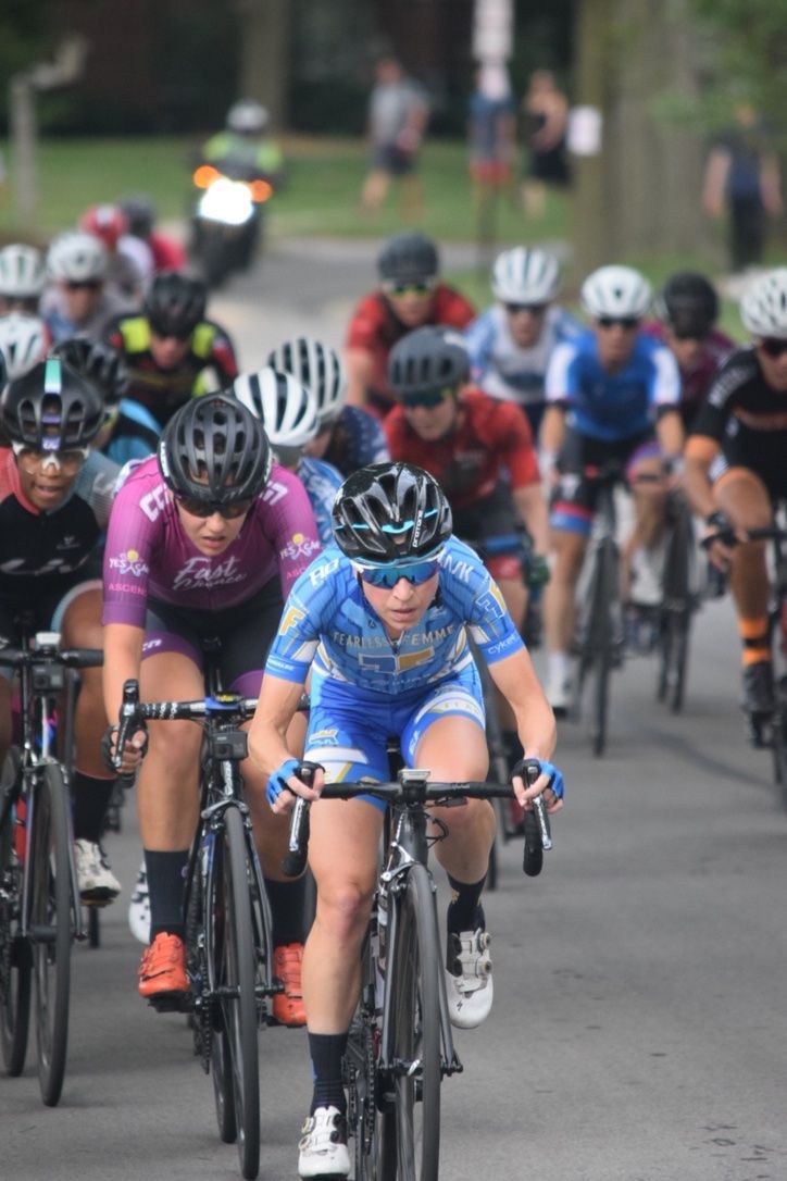 A group of people are riding bicycles down a road