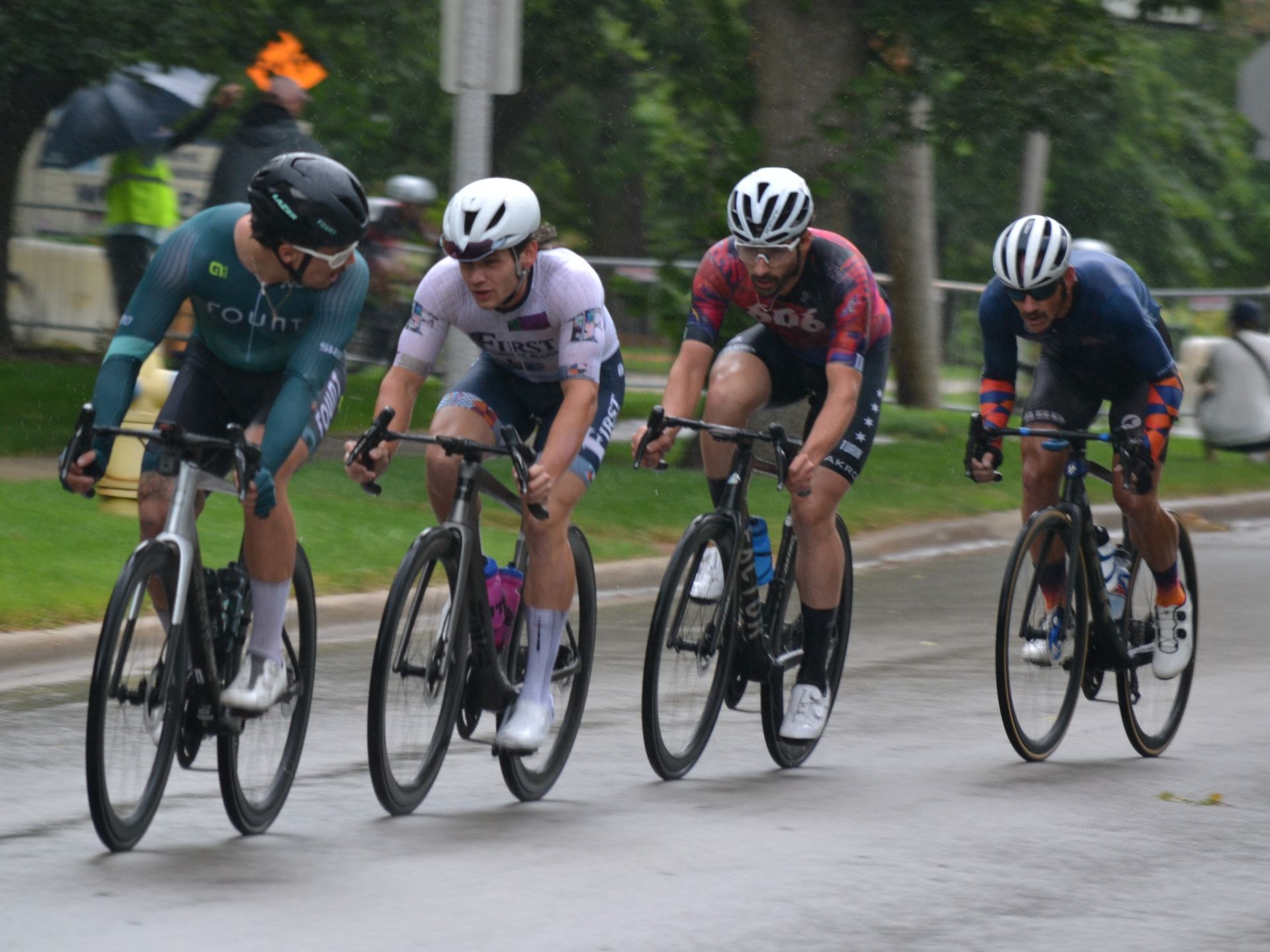 A group of people are riding bicycles down a street.