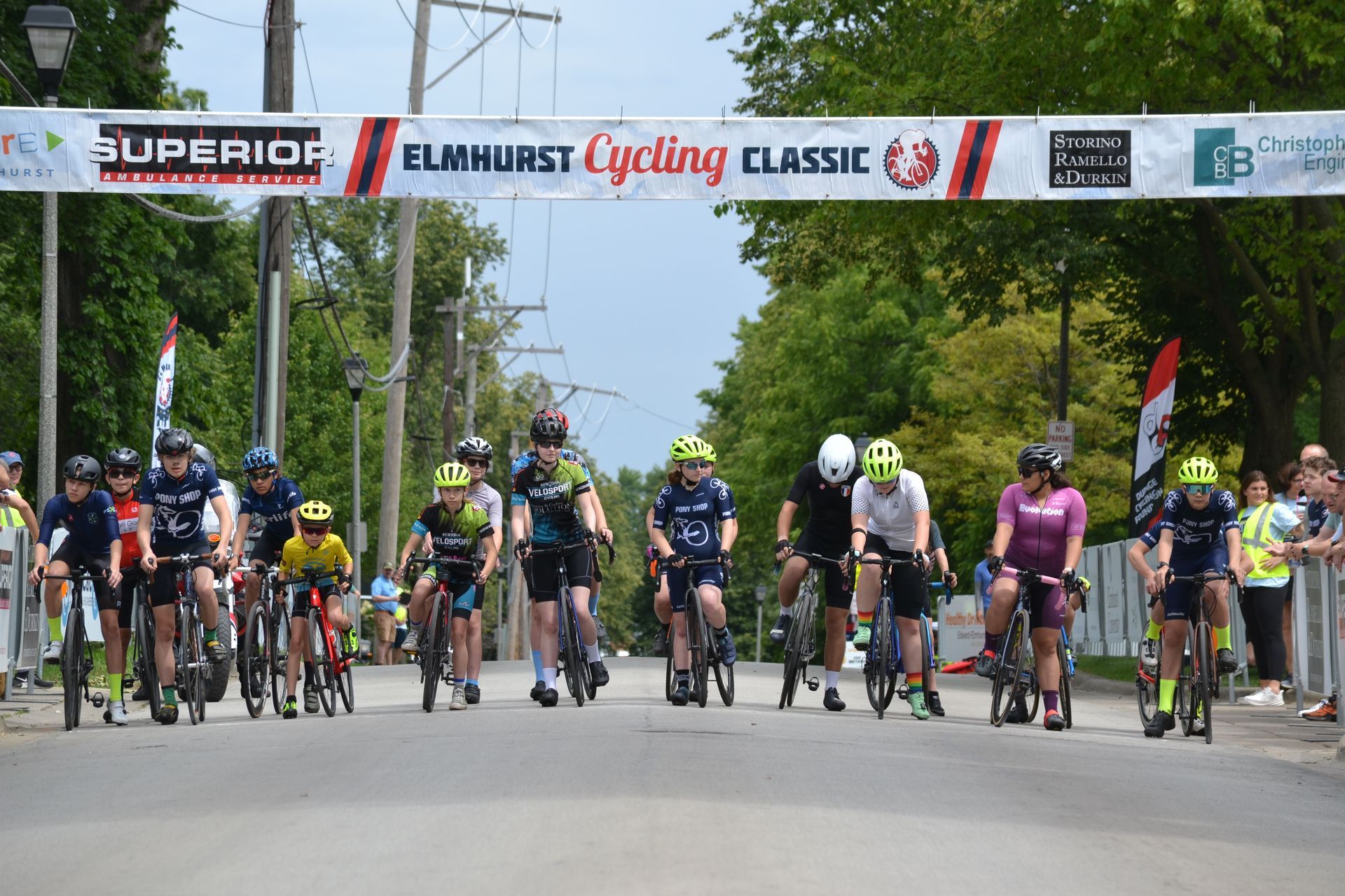 A group of people are riding bicycles down a street.