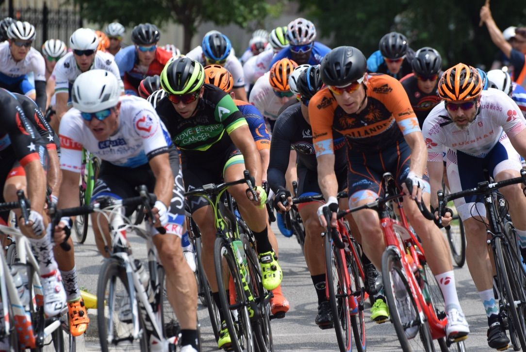 A group of people are riding bicycles down a street.