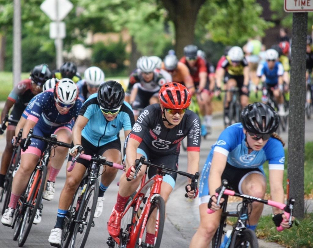 A group of people are riding bicycles down a street.