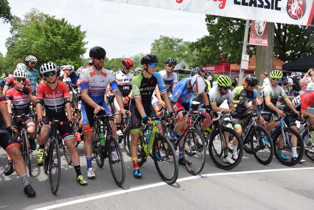 A group of people are riding bicycles down a street.