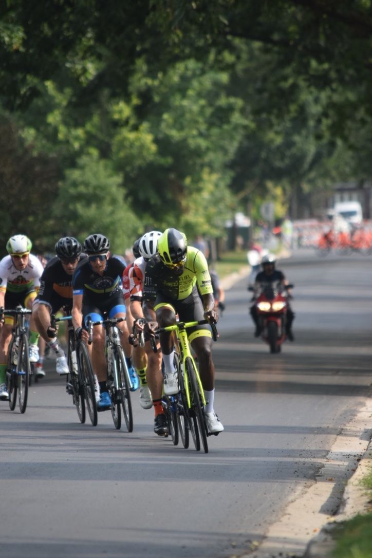 A group of people are riding bicycles down a street.