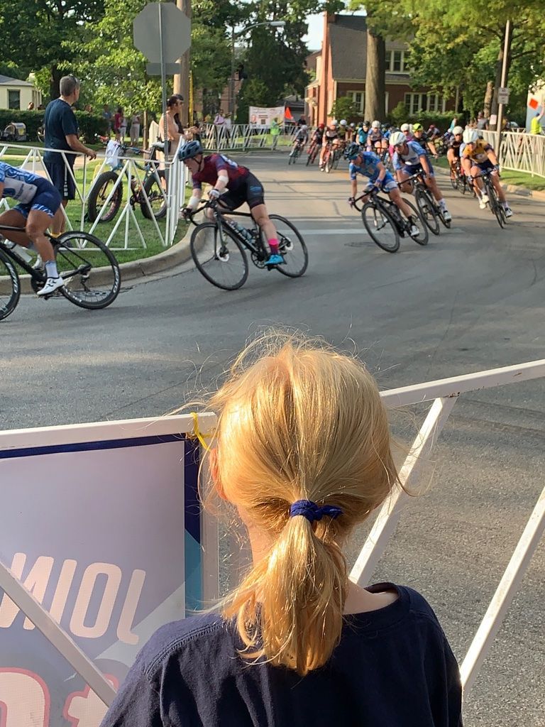 A group of people are riding bicycles down a street.
