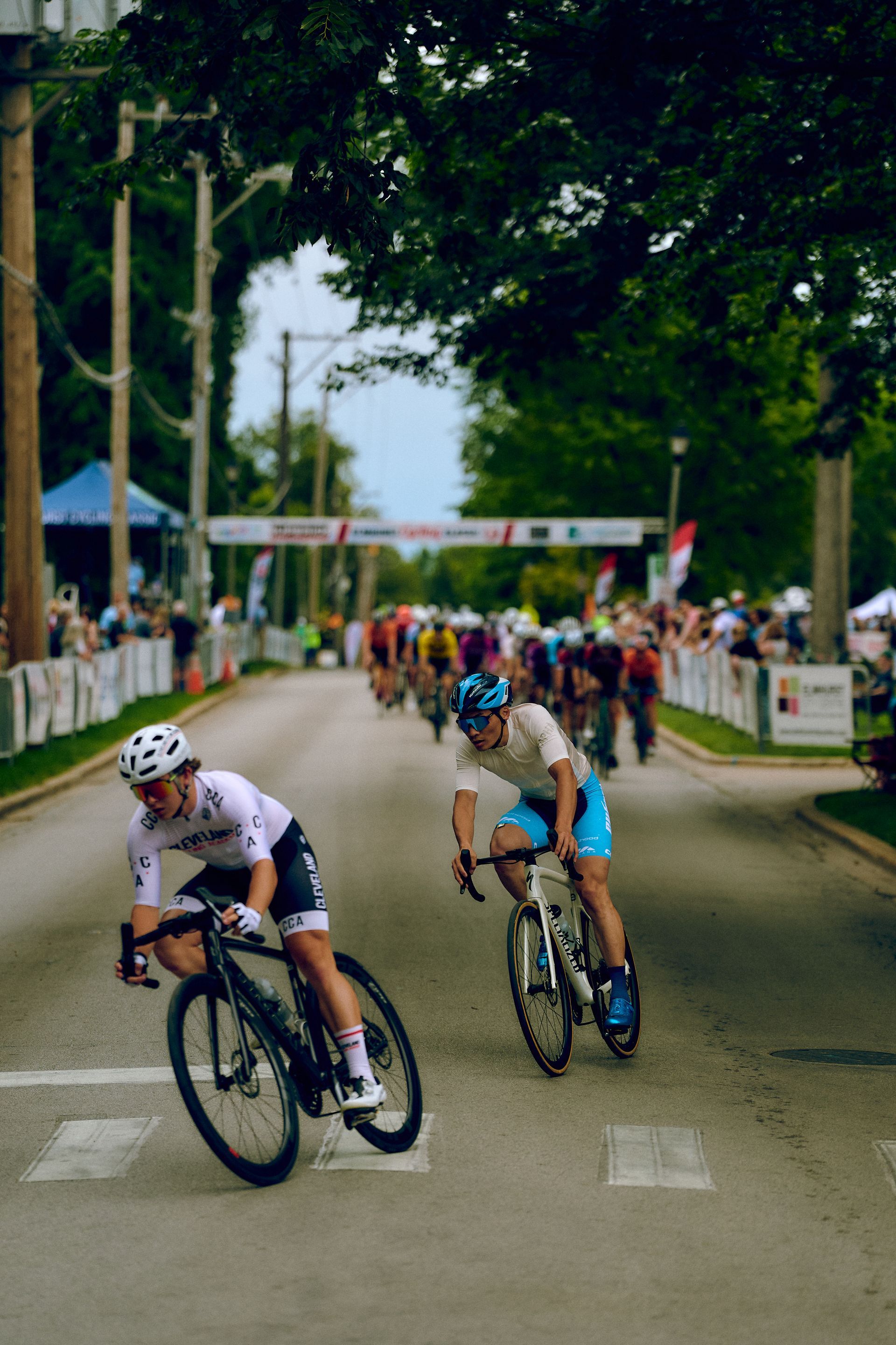 A group of people are riding bicycles down a street.