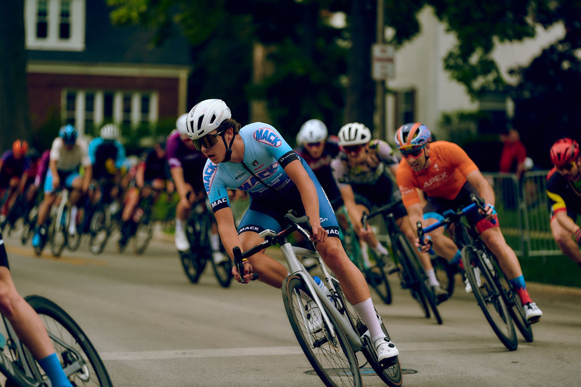 A group of people are riding bicycles down a street.